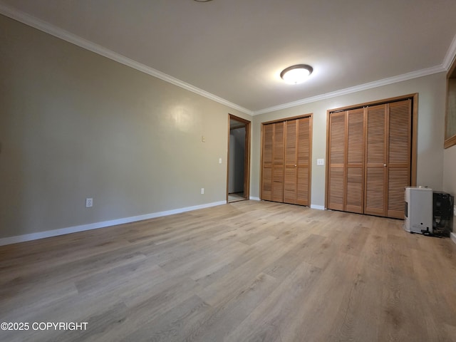 297 Mitkof Hwy, Petersburg, AK 99833 - unfurnished bedroom with two closets, ornamental molding, and light wood-type flooring