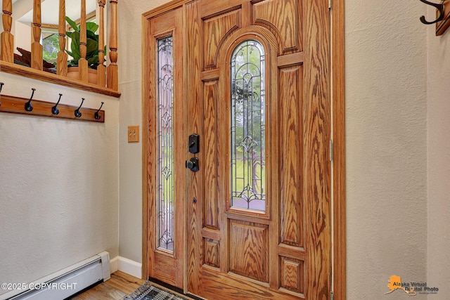 22479 Centurion Dr, Chugiak, AK 99567 - entrance foyer featuring a baseboard radiator, a textured wall, and wood finished floors