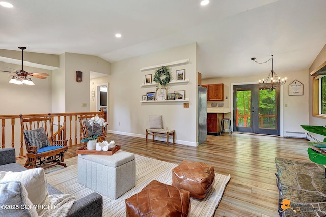 22479 Centurion Dr, Chugiak, AK 99567 - living area featuring vaulted ceiling, light wood-type flooring, a baseboard heating unit, a chandelier, and ceiling fan