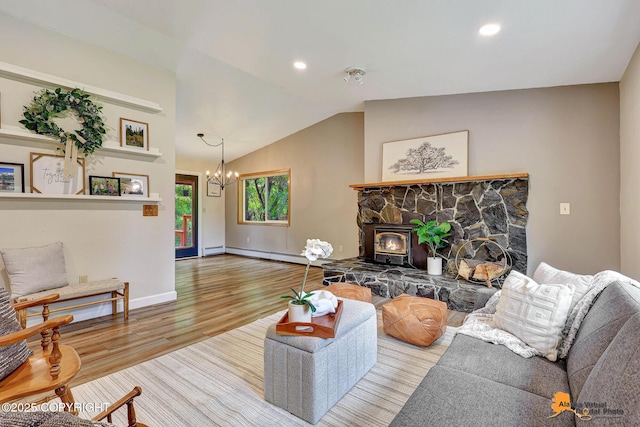 22479 Centurion Dr, Chugiak, AK 99567 - living area featuring a chandelier, wood finished floors, vaulted ceiling, recessed lighting, and a wood stove