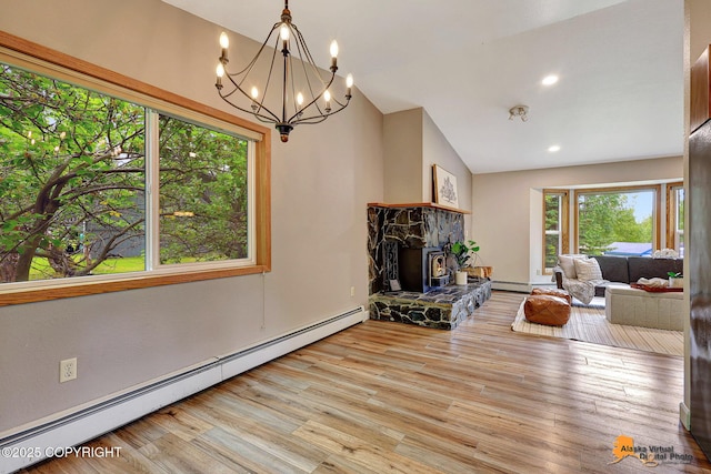 22479 Centurion Dr, Chugiak, AK 99567 - living area featuring a baseboard radiator, vaulted ceiling, wood finished floors, a chandelier, and a fireplace