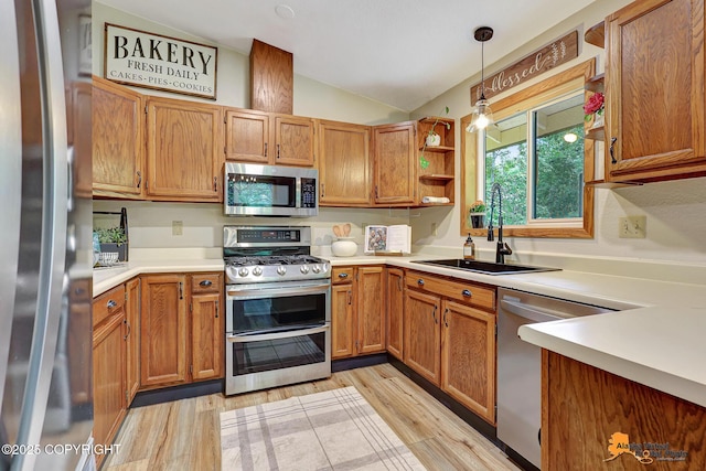 22479 Centurion Dr, Chugiak, AK 99567 - kitchen with stainless steel appliances, vaulted ceiling, decorative light fixtures, light countertops, and light wood-style floors