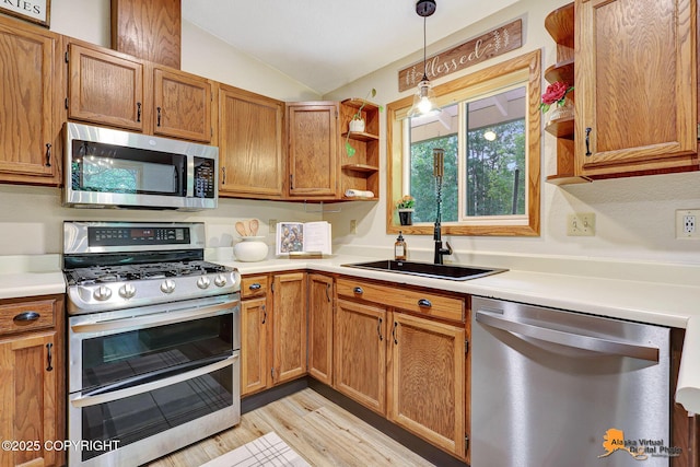 22479 Centurion Dr, Chugiak, AK 99567 - kitchen with appliances with stainless steel finishes, vaulted ceiling, light countertops, open shelves, and light wood-style floors
