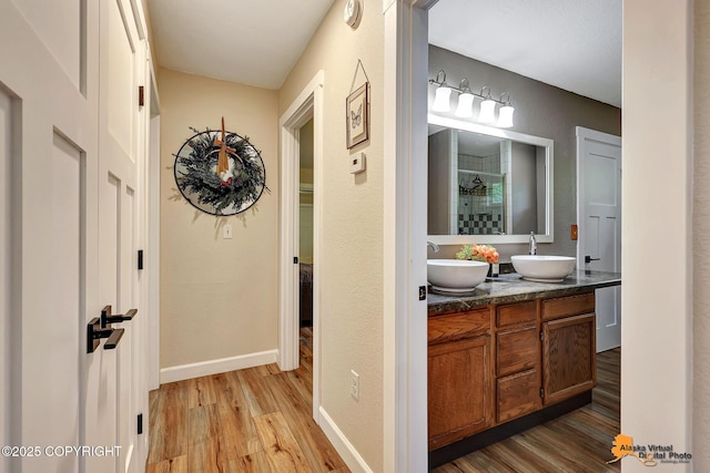 22479 Centurion Dr, Chugiak, AK 99567 - bathroom with wood finished floors, double vanity, and a stall shower