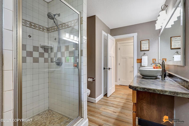 22479 Centurion Dr, Chugiak, AK 99567 - full bath featuring wood finished floors, a shower stall, and vanity