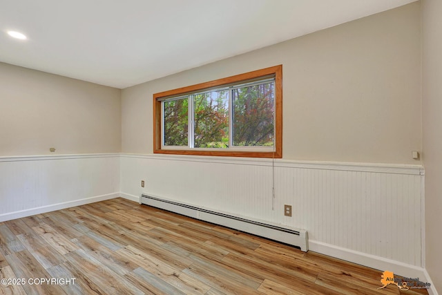 22479 Centurion Dr, Chugiak, AK 99567 - unfurnished room with a baseboard heating unit, wainscoting, wood finished floors, and recessed lighting