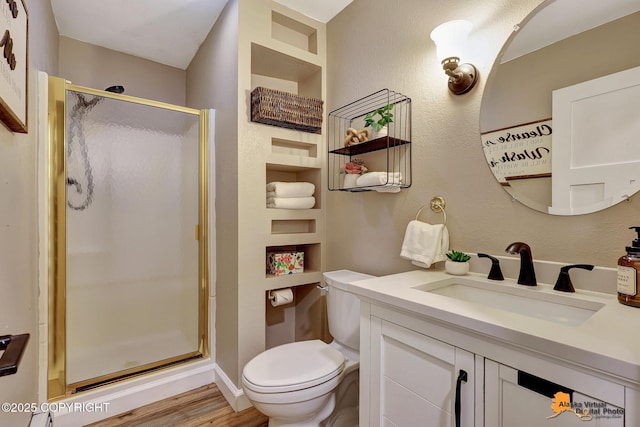 22479 Centurion Dr, Chugiak, AK 99567 - bathroom featuring vanity, a stall shower, wood finished floors, and built in shelves
