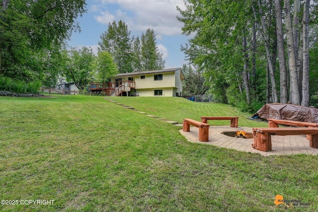 22479 Centurion Dr, Chugiak, AK 99567 - view of green lawn with a wooden deck, a fire pit, and stairway