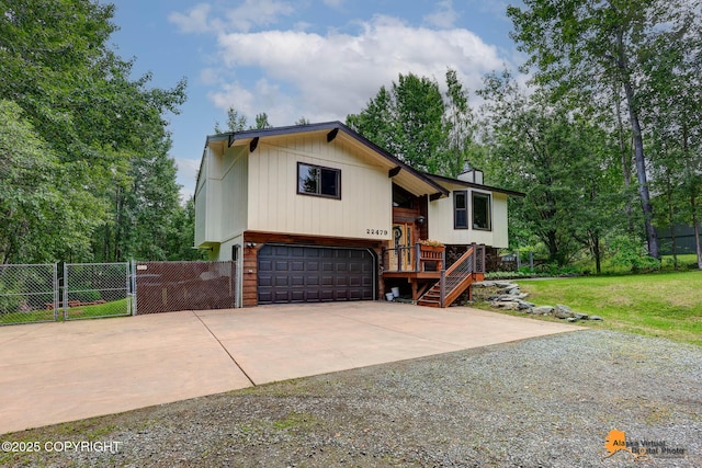 22479 Centurion Dr, Chugiak, AK 99567 - split foyer home with concrete driveway, a garage, a gate, a chimney, and stairway