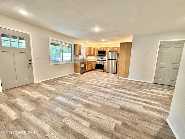 35870 Glory St, Soldotna, AK 99669 - kitchen with stainless steel appliances, light wood finished floors, light countertops, open floor plan, and recessed lighting