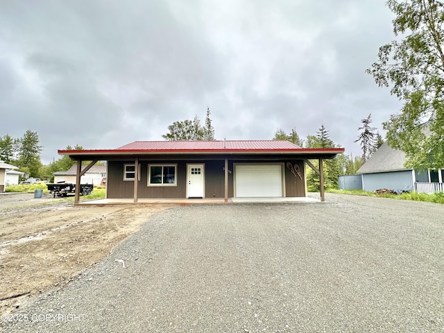35870 Glory St, Soldotna, AK 99669 - single story home featuring an attached garage, gravel driveway, and a metal roof