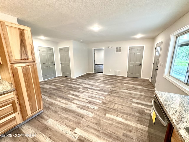 35870 Glory St, Soldotna, AK 99669 - unfurnished living room featuring light wood finished floors and a textured ceiling
