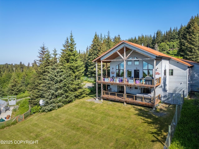 2500 W Highland Dr, Homer, AK 99603 - rear view of house featuring a view of trees, a deck, and a balcony