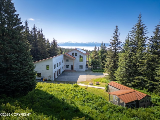 2500 W Highland Dr, Homer, AK 99603 - rear view of property featuring a patio area and a forest view