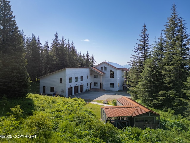 2500 W Highland Dr, Homer, AK 99603 - rear view of property featuring a forest view