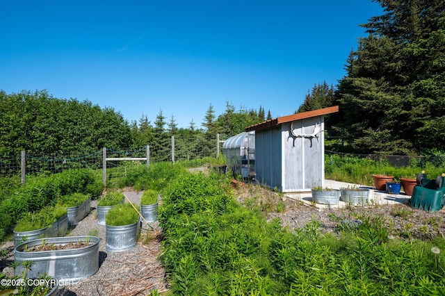 2500 W Highland Dr, Homer, AK 99603 - view of yard featuring a vegetable garden, an outbuilding, and an exterior structure