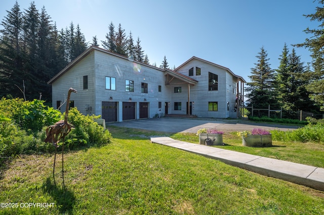 2500 W Highland Dr, Homer, AK 99603 - view of front of house featuring an attached garage, driveway, and a front lawn