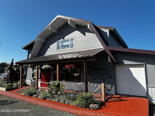 231 Main St, Seldovia, AK 99663 - view of front facade featuring a porch, a standing seam roof, and a metal roof