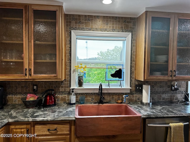 231 Main St, Seldovia, AK 99663 - kitchen featuring dishwasher, decorative backsplash, glass insert cabinets, and brown cabinetry
