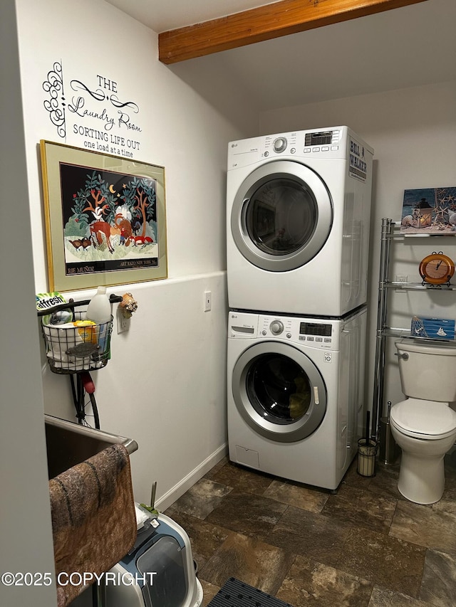 231 Main St, Seldovia, AK 99663 - washroom featuring estacked washer and dryer and dark stone finish floors