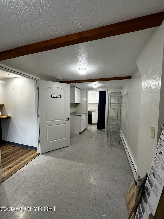 231 Main St, Seldovia, AK 99663 - finished basement with baseboard heating and a textured ceiling