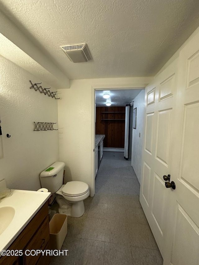 231 Main St, Seldovia, AK 99663 - bathroom with vanity, tile patterned floors, and a textured ceiling