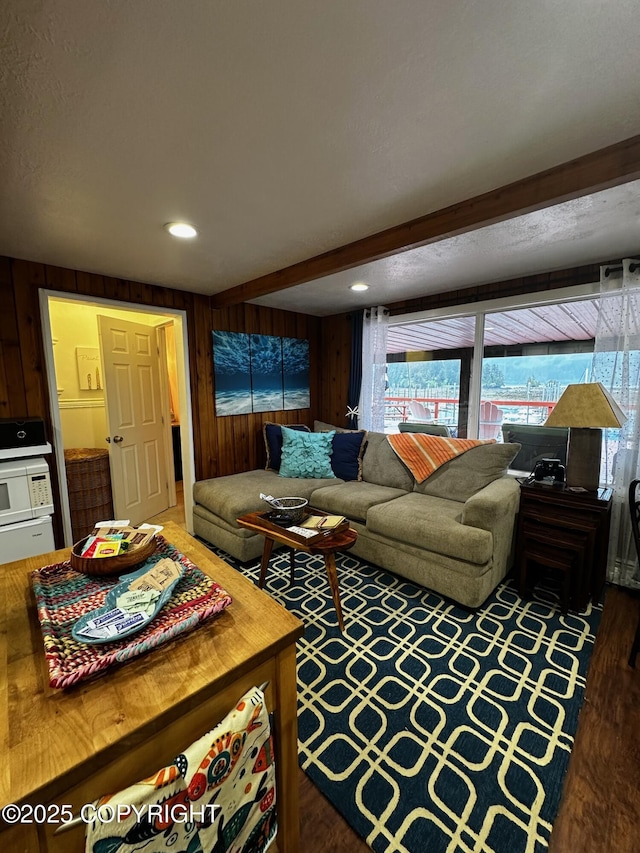 231 Main St, Seldovia, AK 99663 - living room with wood walls, healthy amount of natural light, beamed ceiling, and wood finished floors