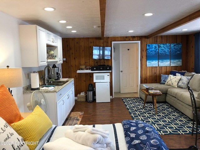 231 Main St, Seldovia, AK 99663 - living room featuring wood walls, beamed ceiling, recessed lighting, and dark wood finished floors