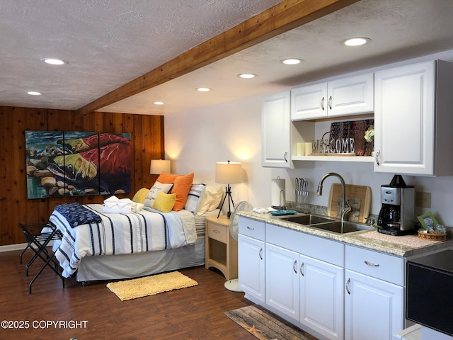 231 Main St, Seldovia, AK 99663 - bedroom featuring wooden walls, beam ceiling, dark wood-style flooring, recessed lighting, and wet bar