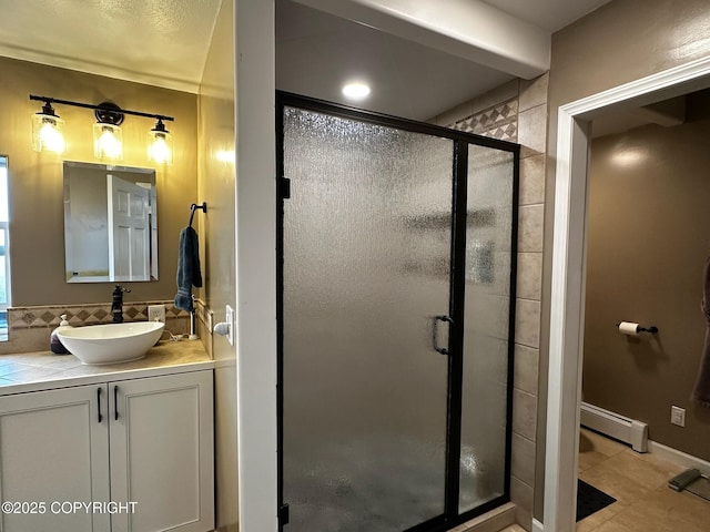 231 Main St, Seldovia, AK 99663 - full bathroom featuring a baseboard heating unit, a stall shower, vanity, backsplash, and tile patterned floors