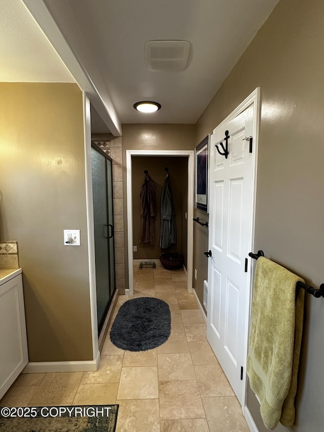 231 Main St, Seldovia, AK 99663 - bathroom featuring a stall shower, vanity, and tile patterned flooring