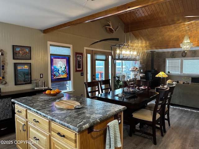 231 Main St, Seldovia, AK 99663 - kitchen featuring dark wood-type flooring, a wood stove, open floor plan, and a chandelier