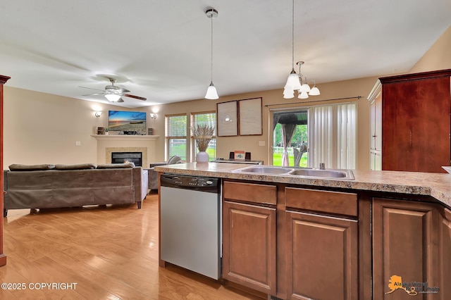 730 N Kimberly St, Wasilla, AK 99654 - kitchen featuring dishwasher, light wood-style floors, a glass covered fireplace, ceiling fan, and a chandelier