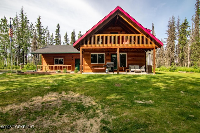 47000 Lexington Ct, Kenai, AK 99611 - back of property featuring faux log siding, a lawn, a wooden deck, outdoor lounge area, and a patio area