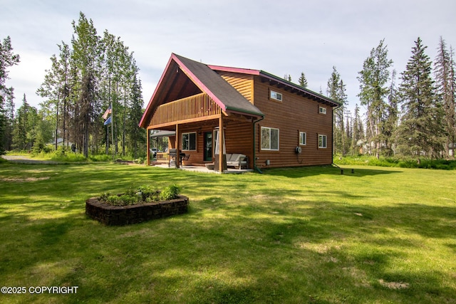 47000 Lexington Ct, Kenai, AK 99611 - back of house featuring a lawn and a patio area
