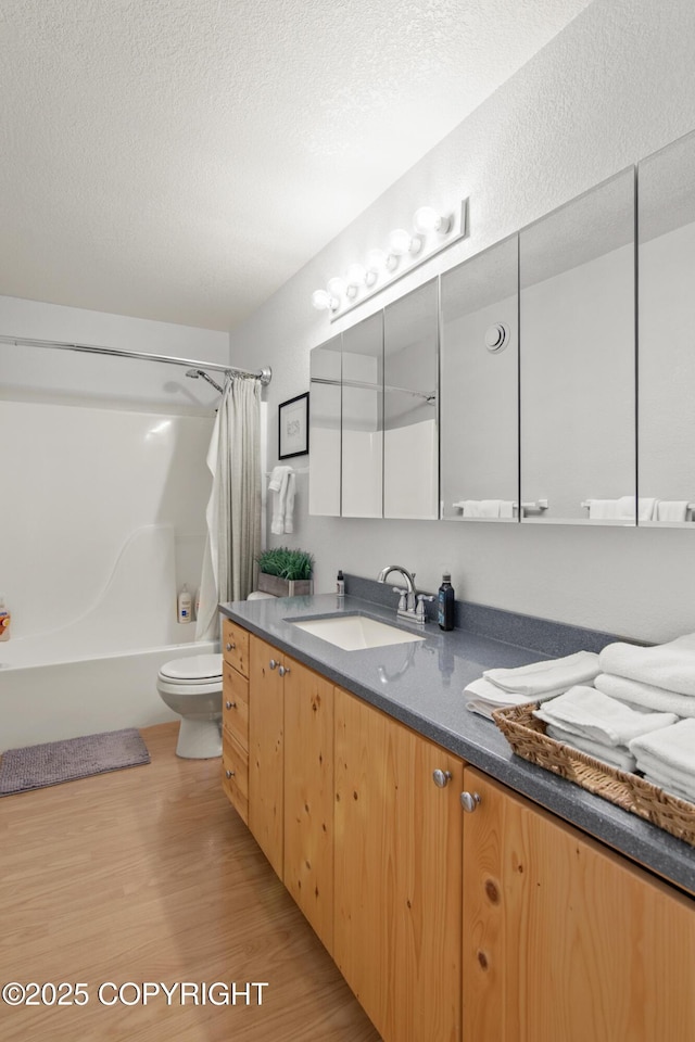 47000 Lexington Ct, Kenai, AK 99611 - bathroom featuring vanity, wood finished floors, shower / bath combo with shower curtain, and a textured ceiling