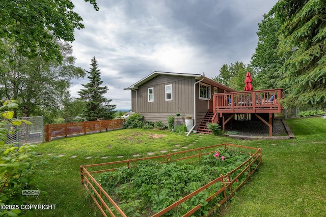 12303 Shiloh Rd, Anchorage, AK 99516 - back of property featuring a vegetable garden, stairway, and a deck