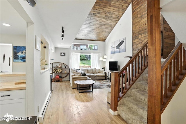 6622 Lakeway Dr, Anchorage, AK 99502 - living room with baseboard heating, light wood finished floors, stairs, high vaulted ceiling, and recessed lighting