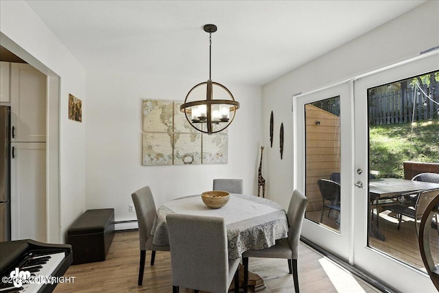 6622 Lakeway Dr, Anchorage, AK 99502 - dining space featuring light wood-style flooring, a chandelier, baseboard heating, and french doors