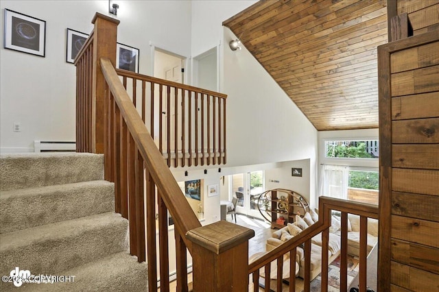 6622 Lakeway Dr, Anchorage, AK 99502 - stairway featuring a baseboard radiator, high vaulted ceiling, and wooden ceiling