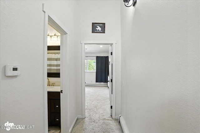 6622 Lakeway Dr, Anchorage, AK 99502 - corridor with light carpet and baseboard heating
