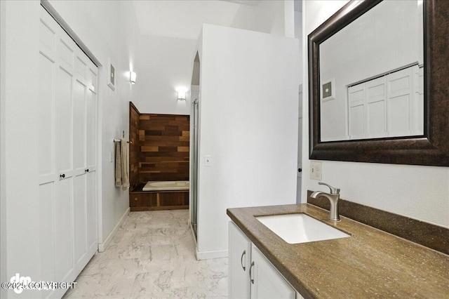 6622 Lakeway Dr, Anchorage, AK 99502 - full bathroom featuring marble finish flooring, vanity, and a tub to relax in