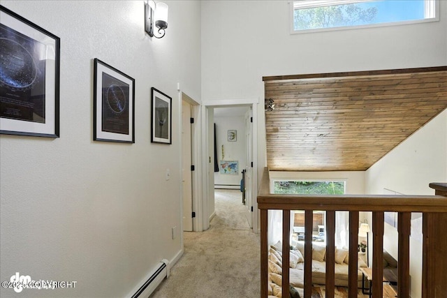 6622 Lakeway Dr, Anchorage, AK 99502 - corridor with light colored carpet, a baseboard radiator, healthy amount of natural light, and wood ceiling