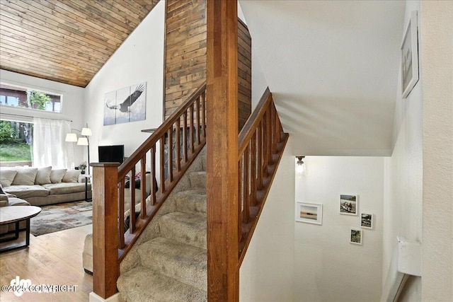 6622 Lakeway Dr, Anchorage, AK 99502 - stairway featuring wood finished floors and high vaulted ceiling