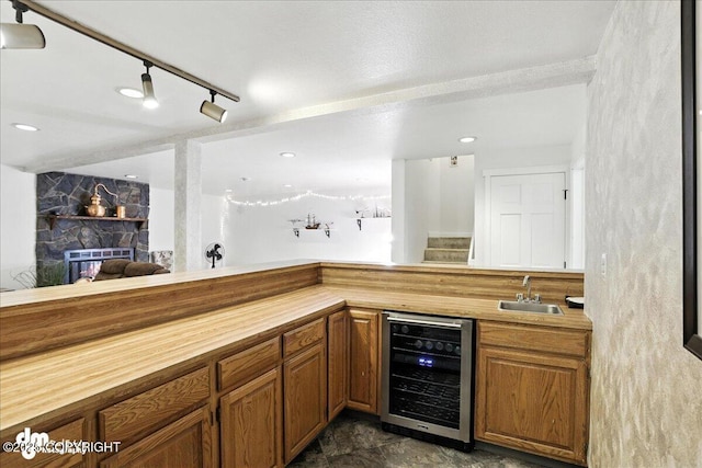 6622 Lakeway Dr, Anchorage, AK 99502 - indoor wet bar featuring wine cooler, rail lighting, and stairway