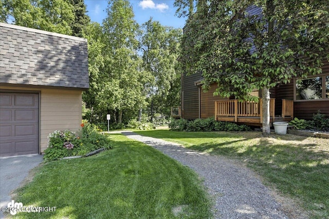 6622 Lakeway Dr, Anchorage, AK 99502 - view of grassy yard with a garage