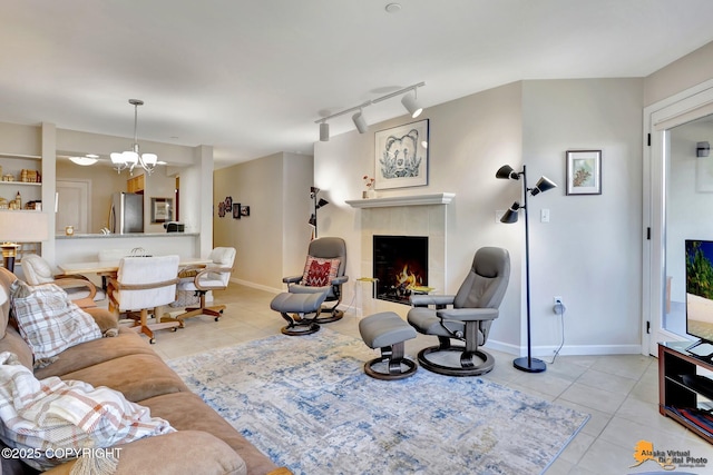 1200 I St Unit 314, Anchorage, AK 99501 - tiled living area with track lighting, a tile fireplace, and a chandelier