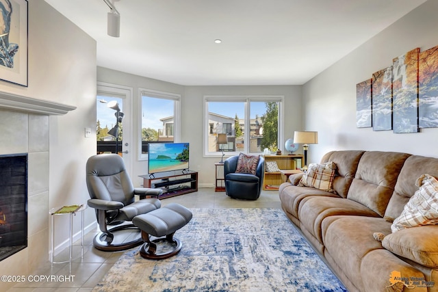 1200 I St Unit 314, Anchorage, AK 99501 - tiled living area featuring a tile fireplace and baseboards