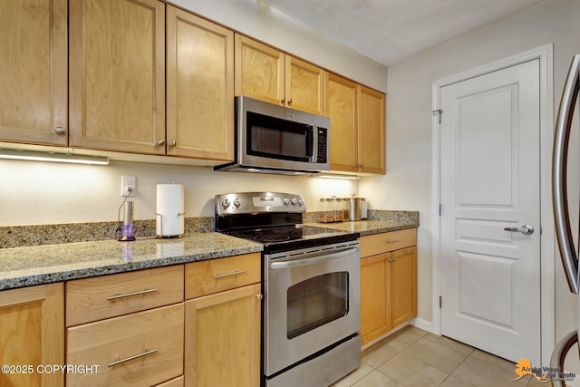 1200 I St Unit 314, Anchorage, AK 99501 - kitchen featuring stainless steel appliances, light brown cabinetry, light tile patterned floors, and light stone countertops