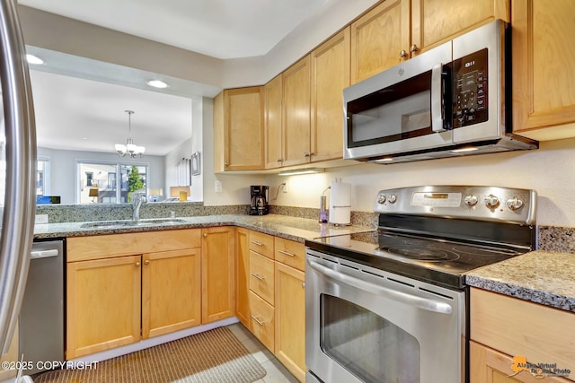 1200 I St Unit 314, Anchorage, AK 99501 - kitchen with appliances with stainless steel finishes, a chandelier, light brown cabinets, recessed lighting, and light stone counters
